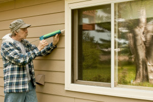 man using a caulking gun